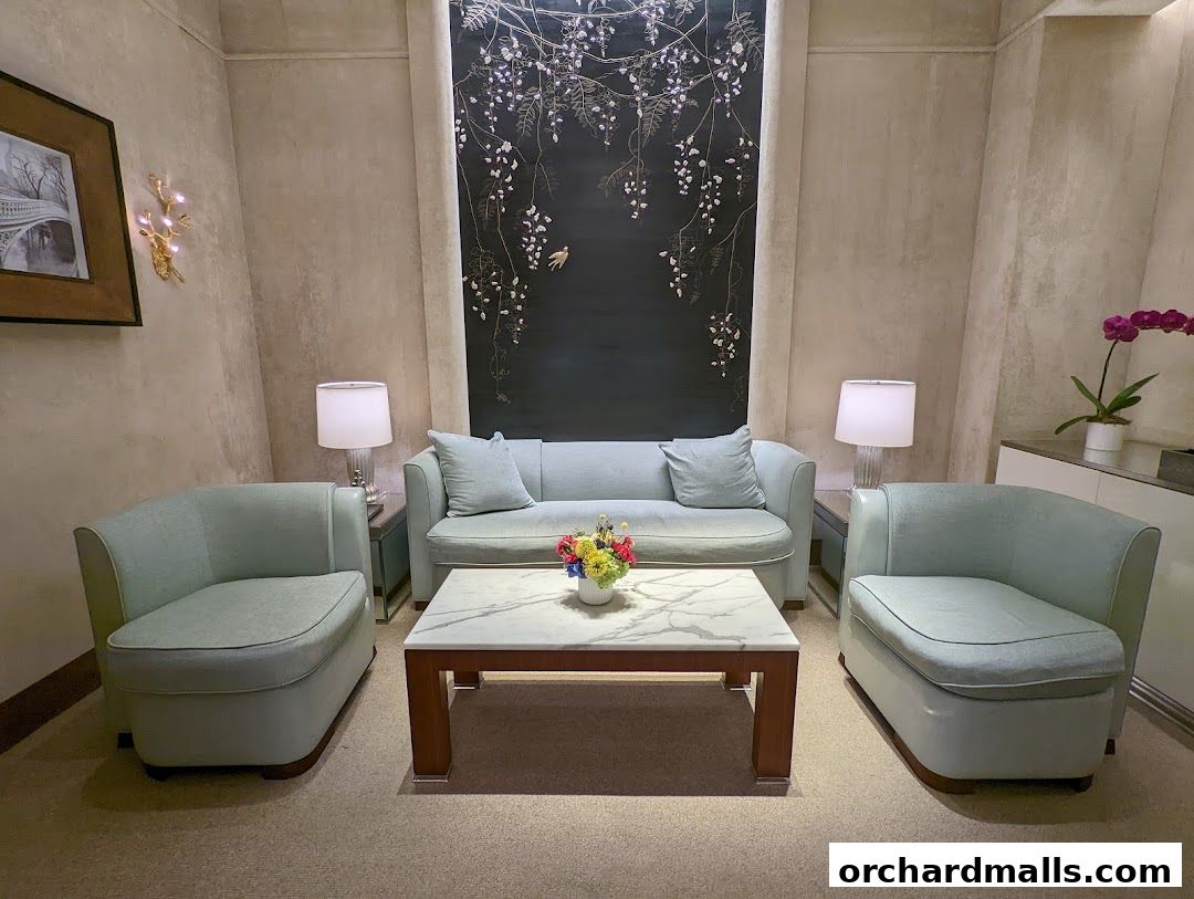 A serene seating area with light blue sofas, chairs, and a marble coffee table.