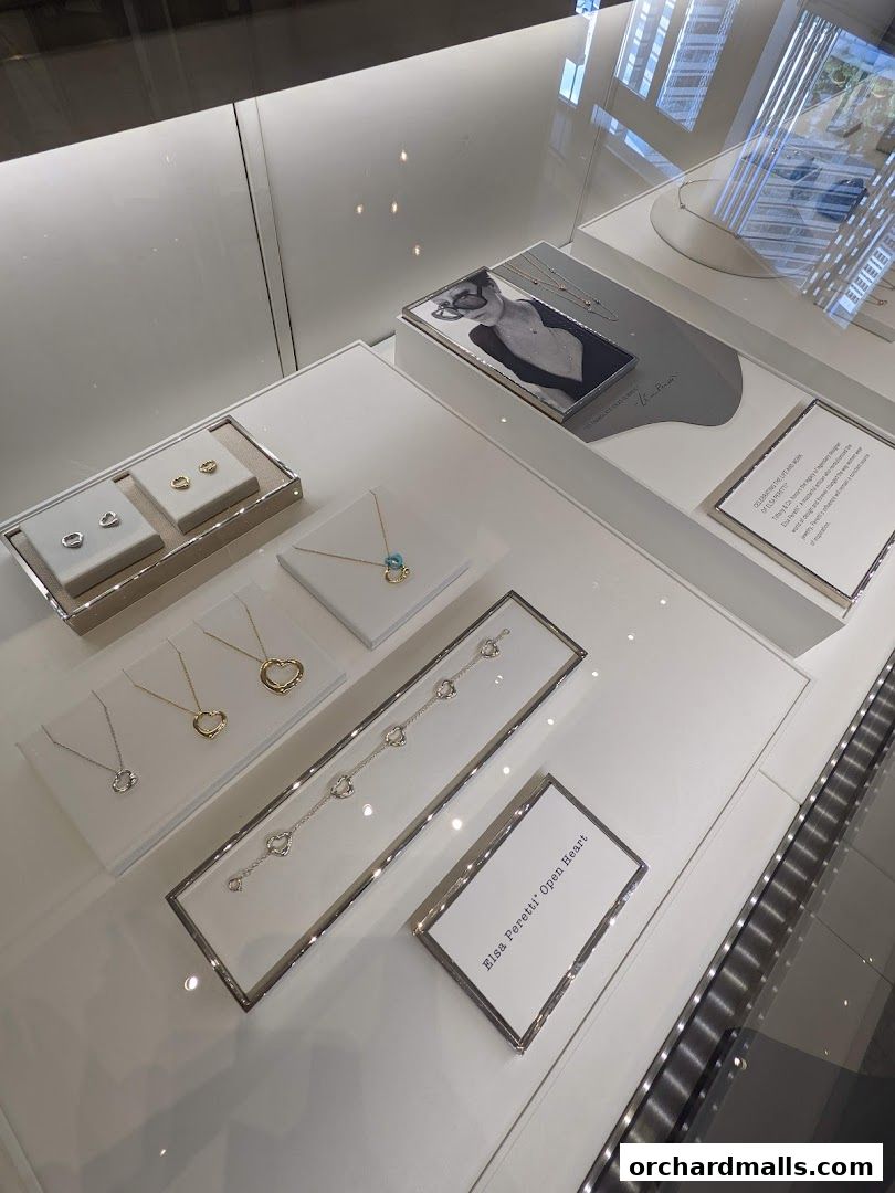 A display case showcasing Tiffany & Co. jewelry, including necklaces, earrings, and bracelets.