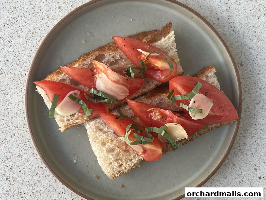 A plate of bruschetta topped with fresh tomatoes, garlic, and basil.