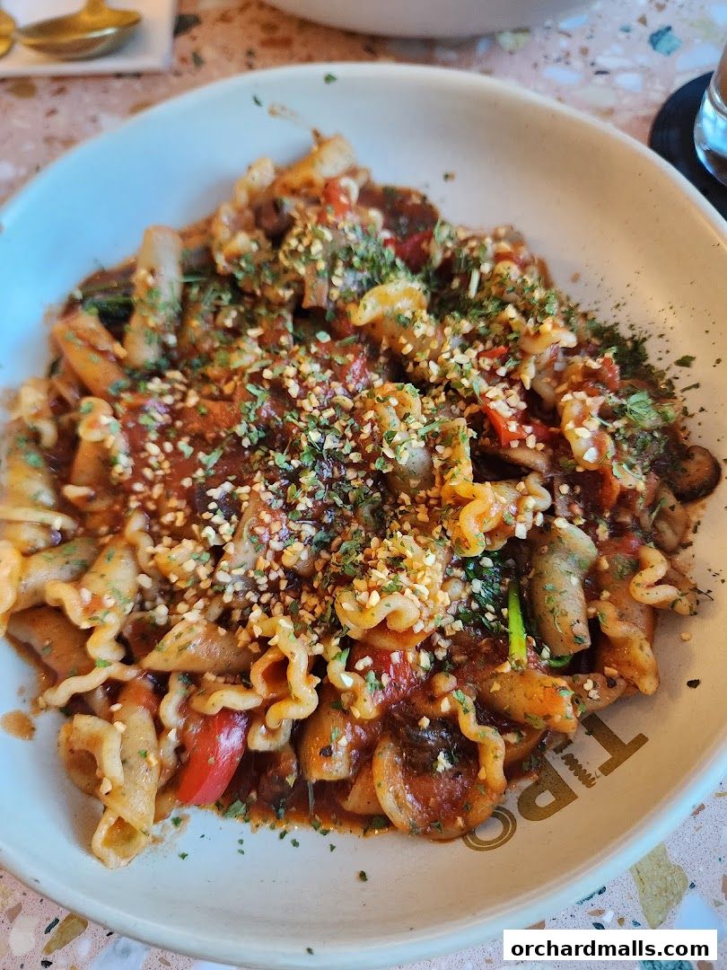A close-up shot of a delicious pasta dish with sauce and herbs.