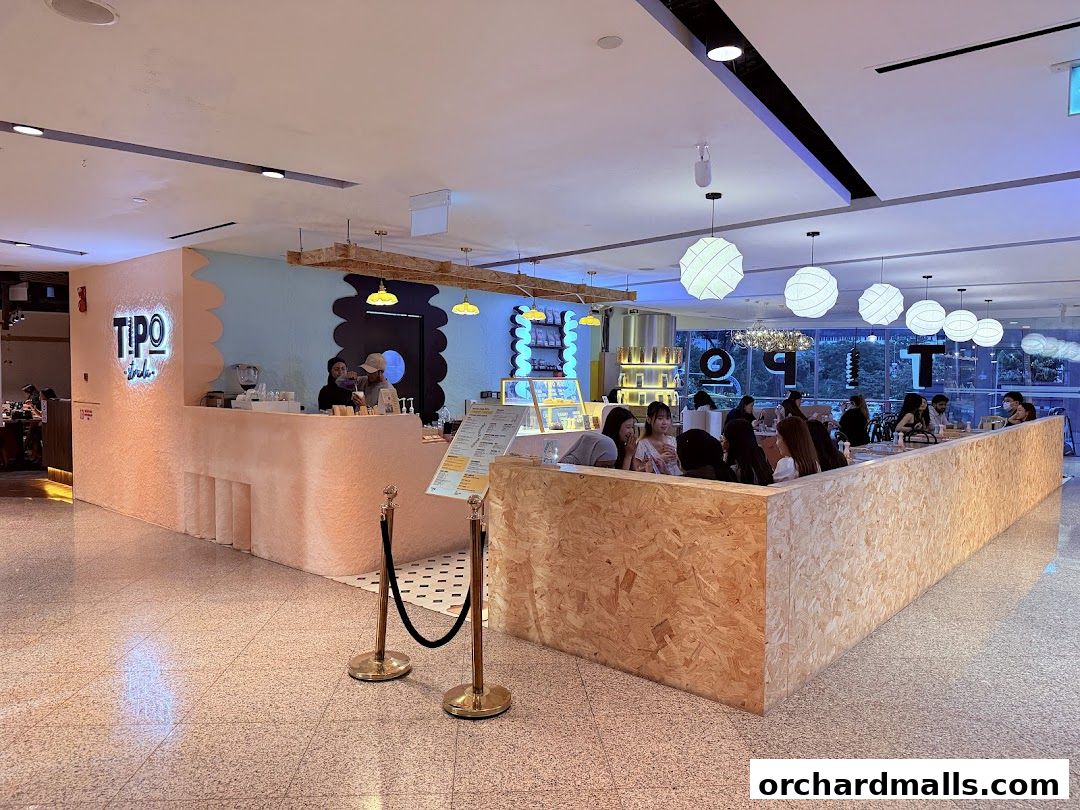 Interior view of Tipo Strada Wheelock cafe with customers seated and staff at the counter.