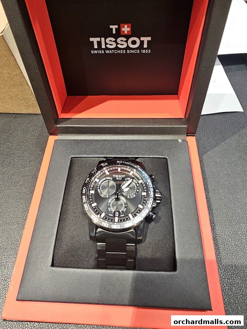 A Tissot watch in its presentation box, featuring the brand's logo and tagline.