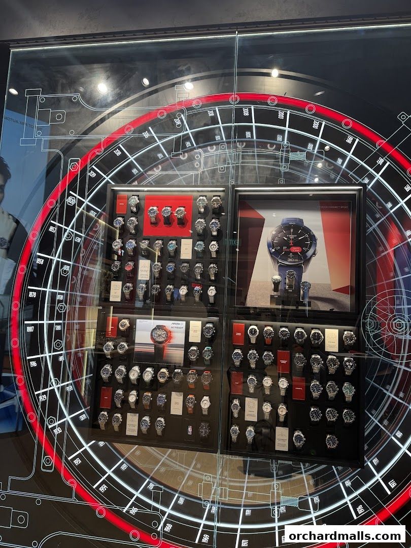 A display window showcasing a variety of Tissot watches with a circular graphic design.