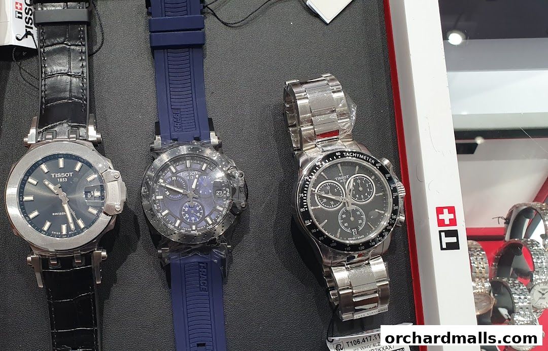 A close-up view of three Tissot watches, showcasing their intricate designs and straps.