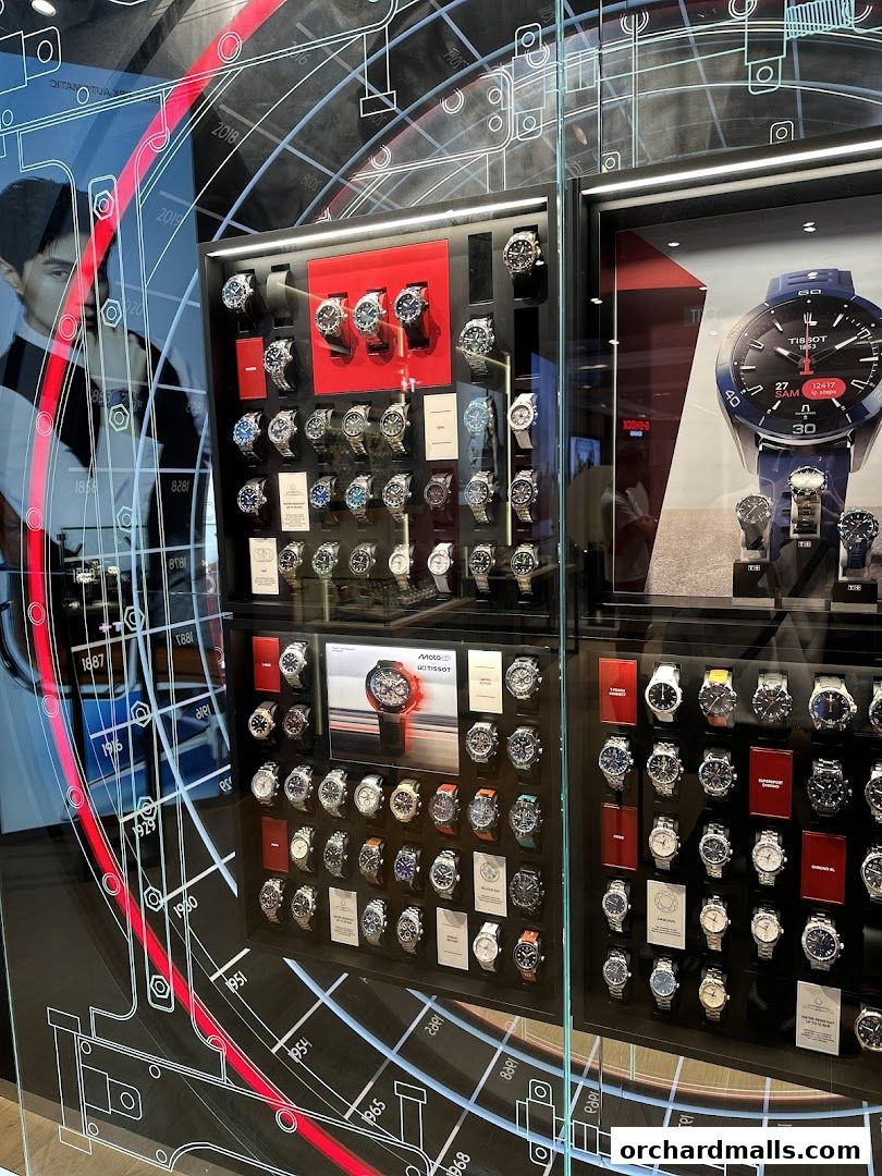 A Tissot watch shop window displaying a variety of watches and a large promotional image.
