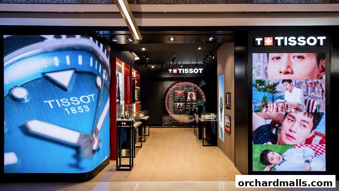 Interior view of a Tissot watch store with large digital displays showcasing watches and models.