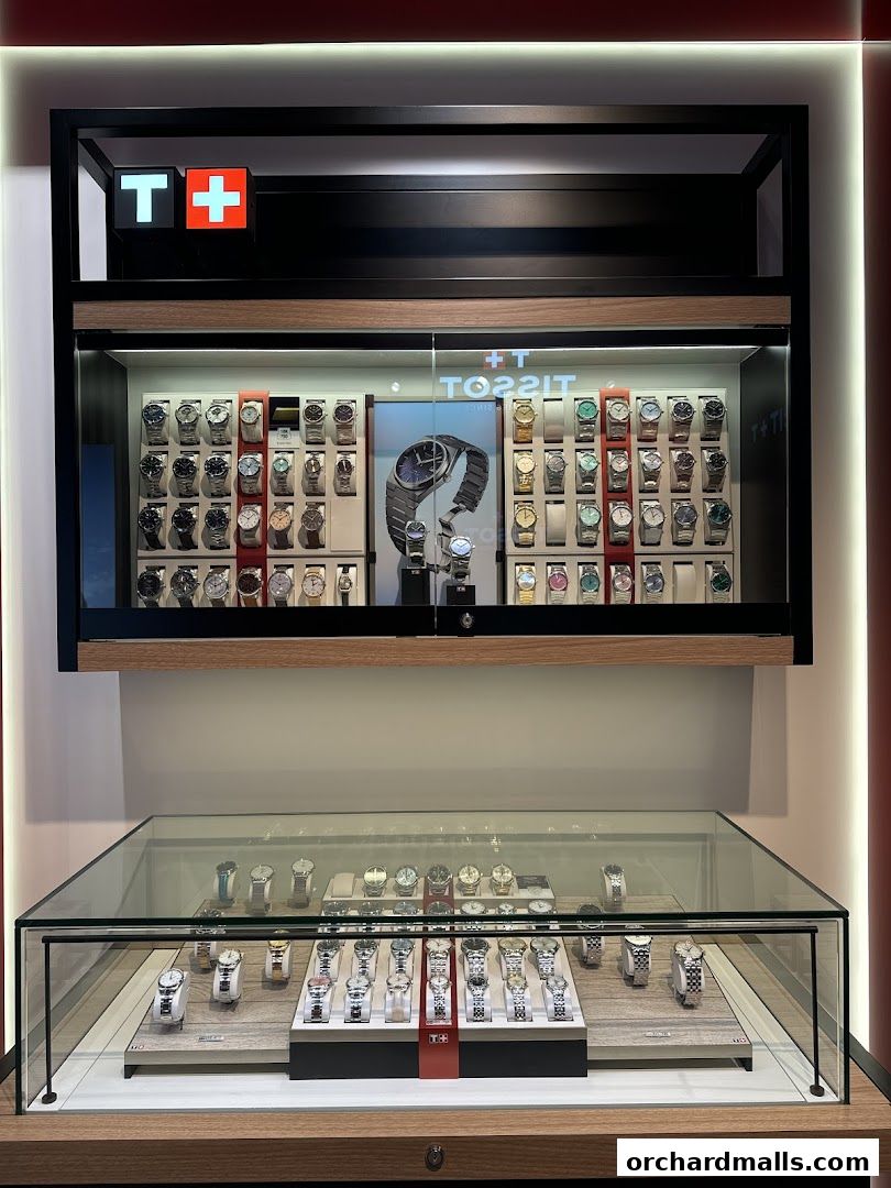 A Tissot watch store display featuring numerous watches in glass cases and on shelves.
