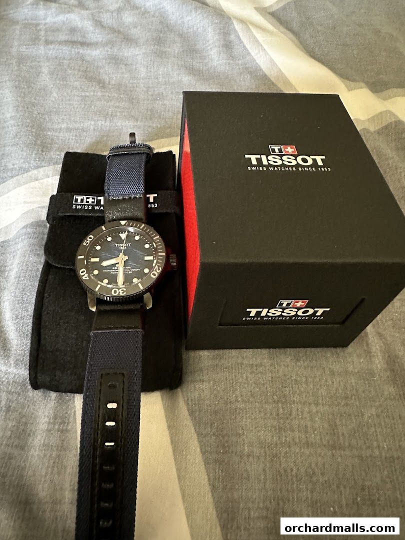A Tissot watch with its box and pouch, showcasing Swiss craftsmanship.