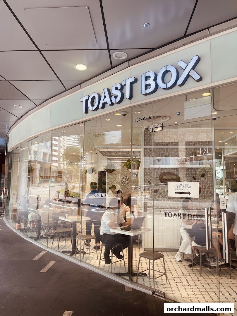 Exterior view of Toast Box ION Orchard with customers seated inside.