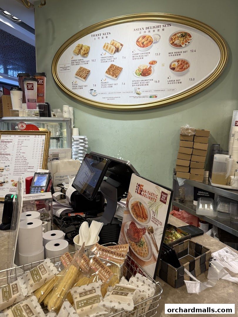 A counter display with menus and food items at Toast Box ION Orchard.