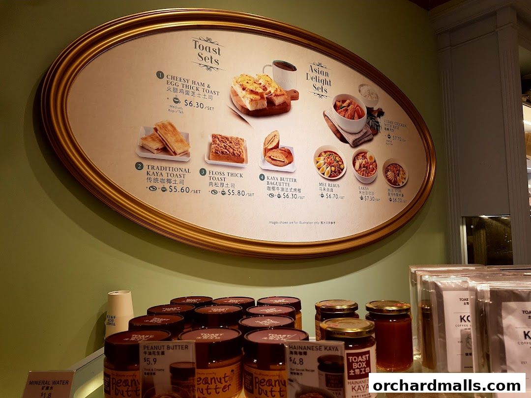 A menu board displaying various toast sets and Asian delights at Toast Box.