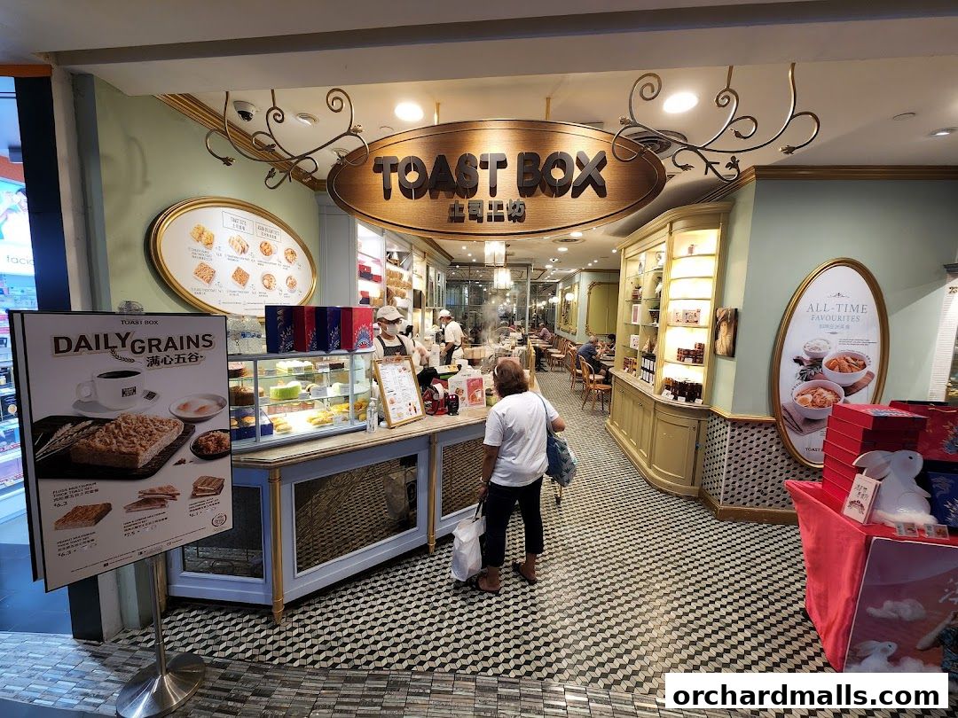 Interior view of Toast Box ION Orchard, showcasing display cases with food and seating area.