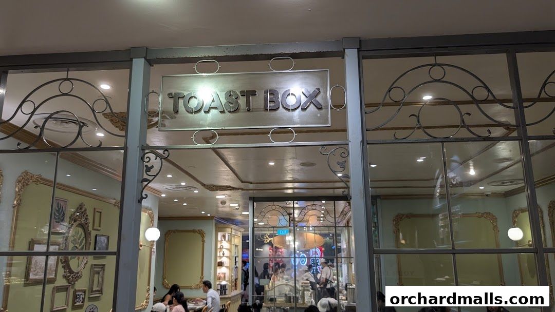 The entrance to Toast Box ION Orchard, featuring decorative metalwork and a prominent sign.