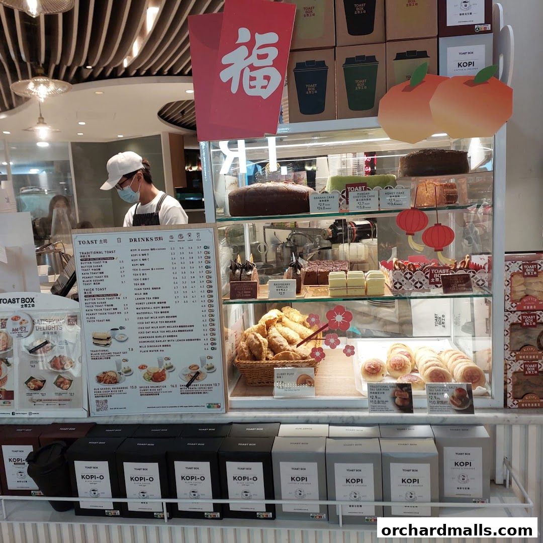 A display case filled with cakes, pastries, and drinks at Toast Box ION Orchard.