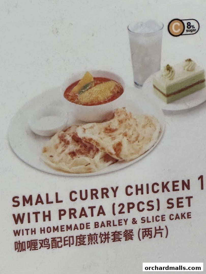 A set meal featuring curry chicken with prata, barley drink, and slice cake.