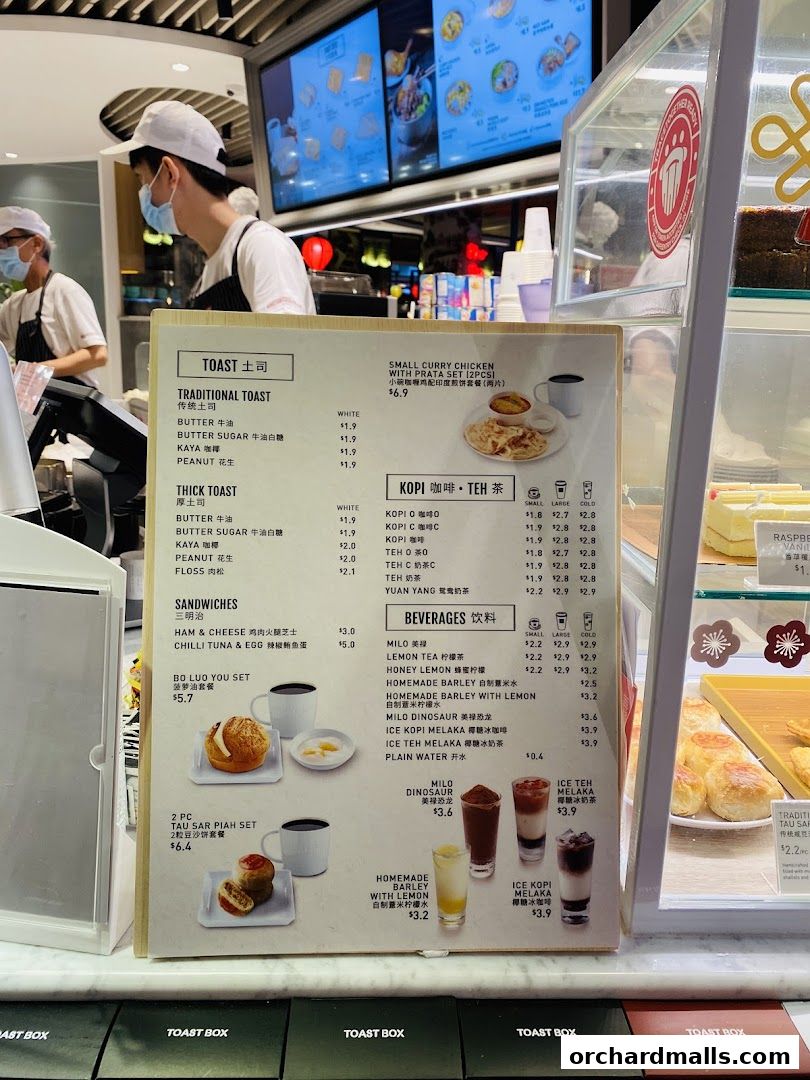 A menu board displaying various toast, sandwiches, drinks, and set meals from Toast Box.