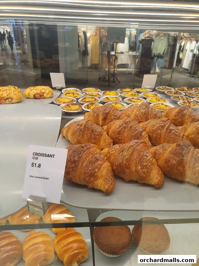 A display of freshly baked croissants and pastries at Toast Box Wheelock Place.