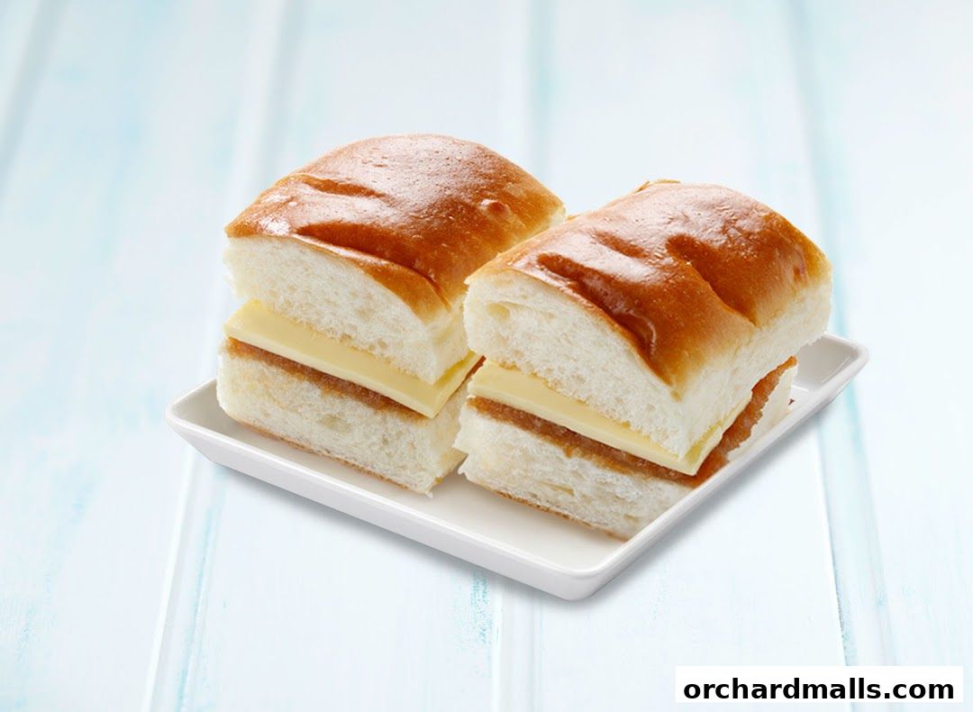 Two delicious kaya and butter toast sandwiches served on a white plate.