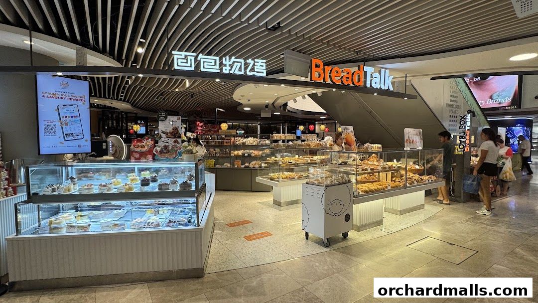 BreadTalk bakery shop displaying a variety of cakes, pastries, and bread in display cases.