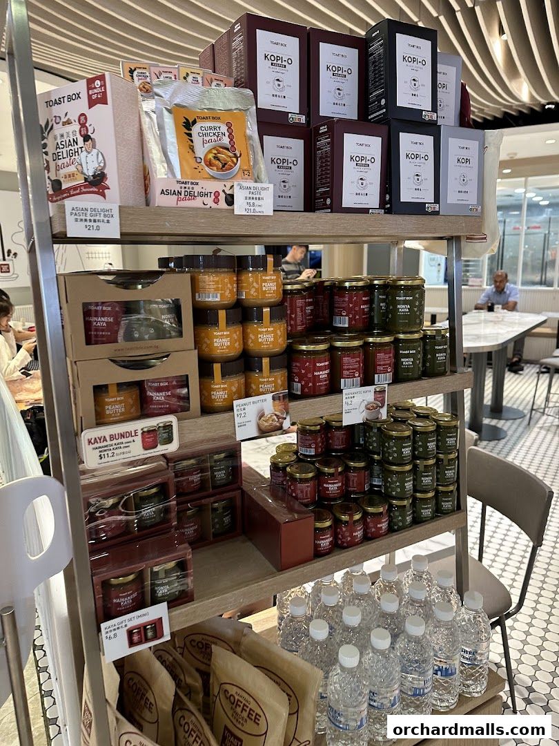 Shelves stocked with various Toast Box products including pastes, jams, coffee, and bottled water.