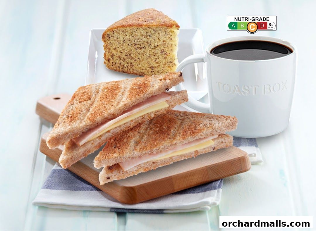 A slice of cake, ham and cheese toasties, and a cup of coffee from Toast Box.