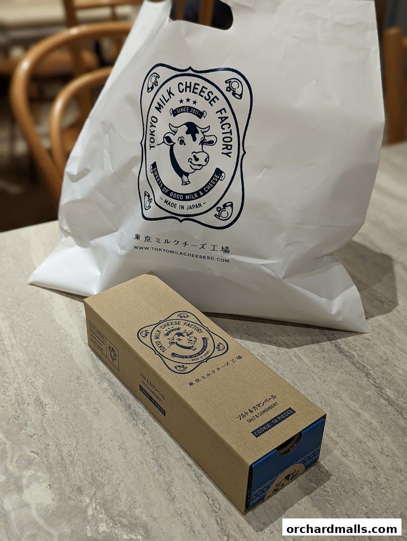 A shopping bag and a box of cookies from Tokyo Milk Cheese Factory.