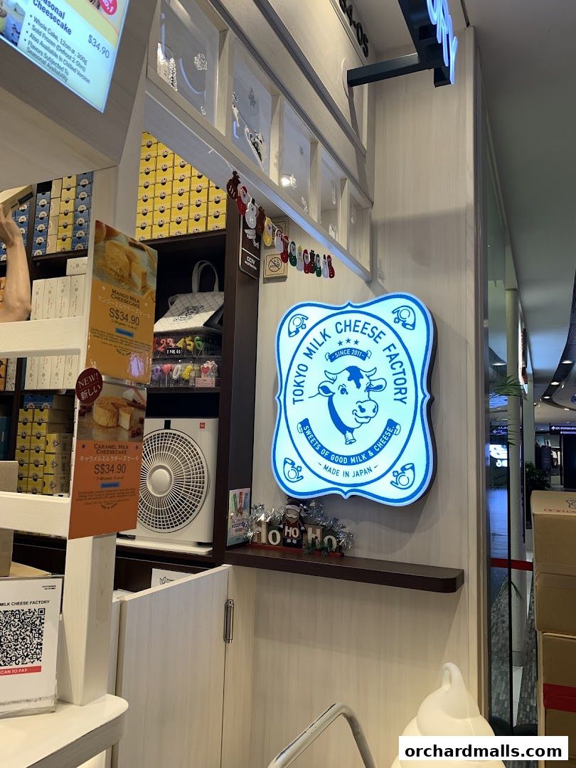 The Tokyo Milk Cheese Factory shop front with its signature blue and white logo and product displays.