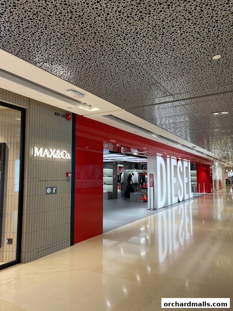 The entrance to the Diesel store at ION Orchard, featuring large illuminated signage and a modern interior.