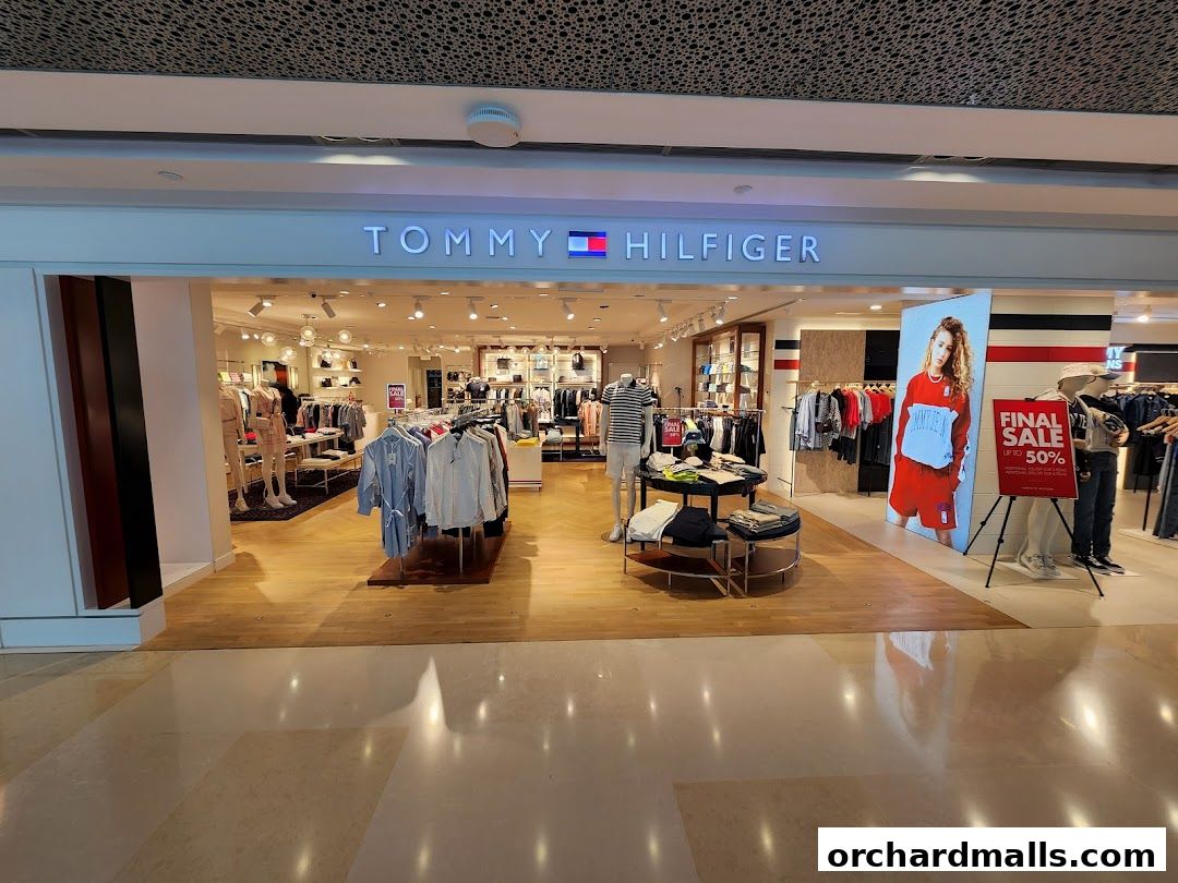 The entrance of a Tommy Hilfiger store showcasing clothing displays and a 'Final Sale' banner.