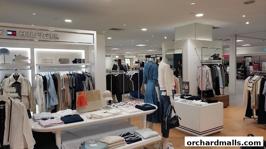 Interior view of a Tommy Hilfiger store showcasing clothing on racks and mannequins.