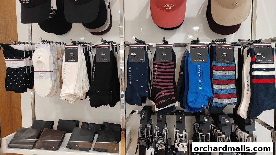 A display of Tommy Hilfiger socks and wallets, with caps on top.
