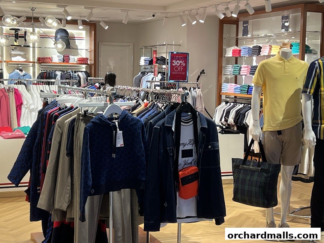 Interior view of a Tommy Hilfiger store showcasing men's and women's apparel and accessories.