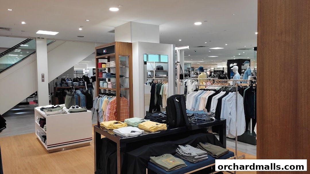 Interior view of a Tommy Hilfiger store showcasing folded and hung apparel.