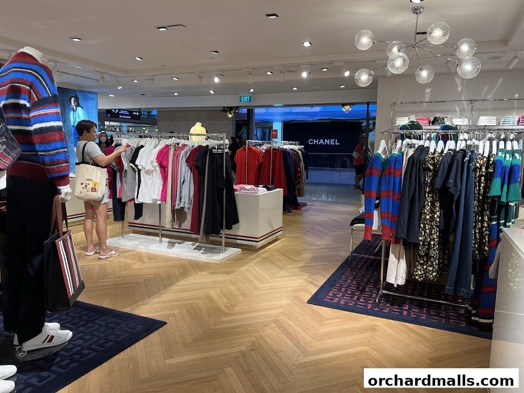 Interior view of a Tommy Hilfiger store with clothing racks and mannequins.