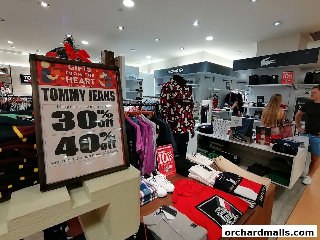 Tommy Hilfiger store interior with sale signs and clothing displays.