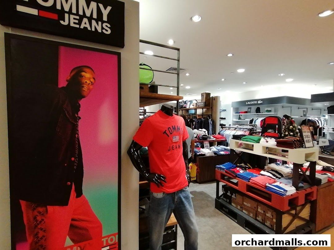 Interior of a Tommy Hilfiger store showcasing apparel and mannequins.
