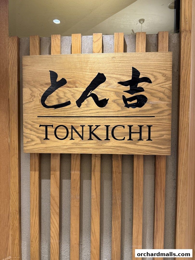 A wooden sign with Japanese characters and "TONKICHI" in English.