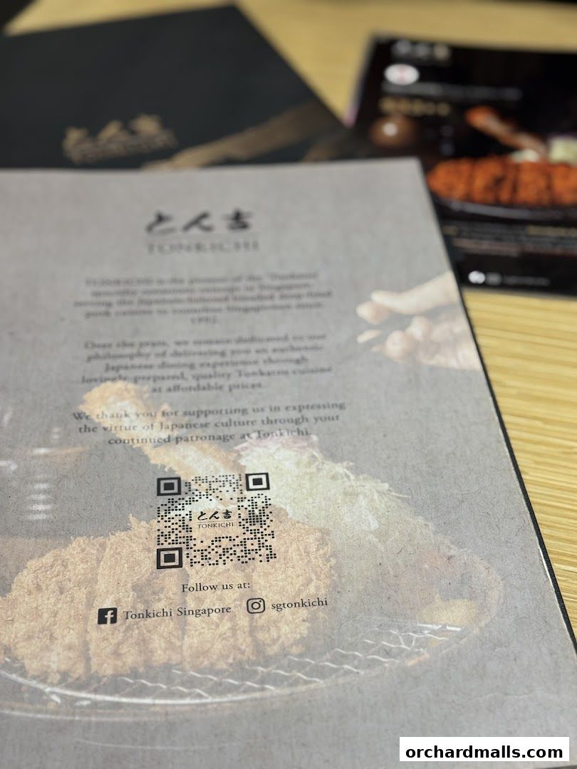 A menu from Tonkichi restaurant featuring Japanese cuisine and social media links.