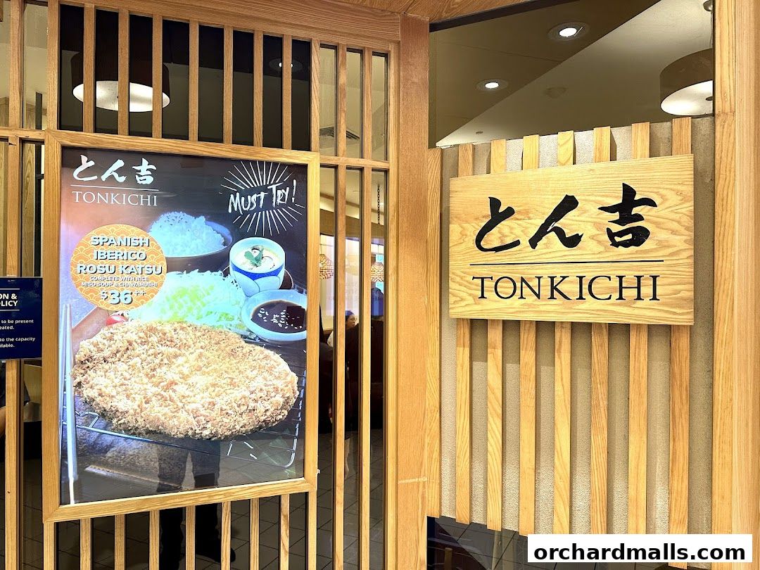 The entrance of Tonkichi restaurant featuring a sign and a promotional poster for Spanish Iberico Rosu Katsu.