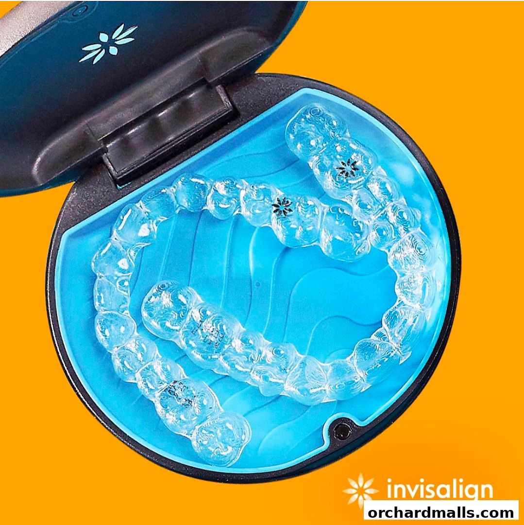 A close-up of clear aligners in a blue case, with the Invisalign logo visible.
