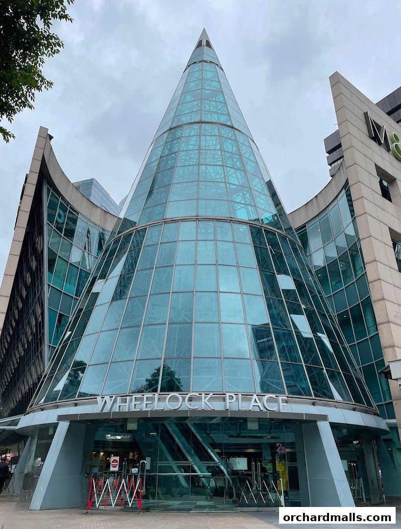 The striking glass facade of Wheelock Place, a modern shopping destination.
