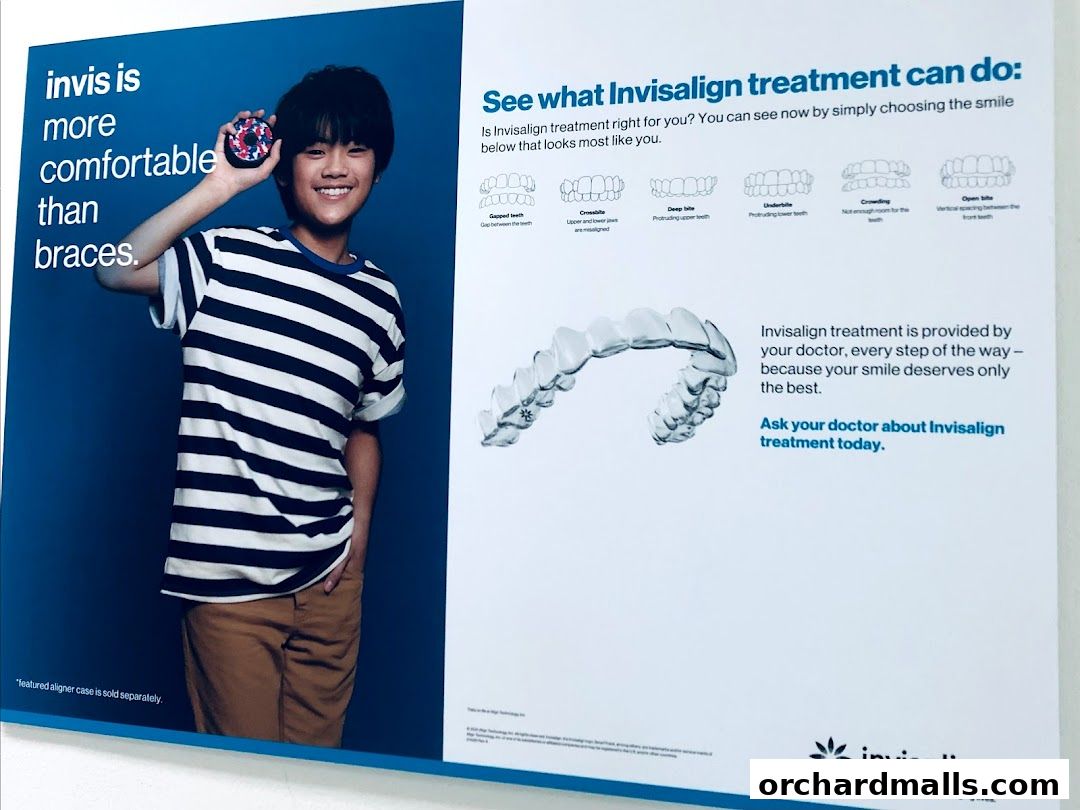 A poster advertising Invisalign treatment with a boy holding an aligner case.