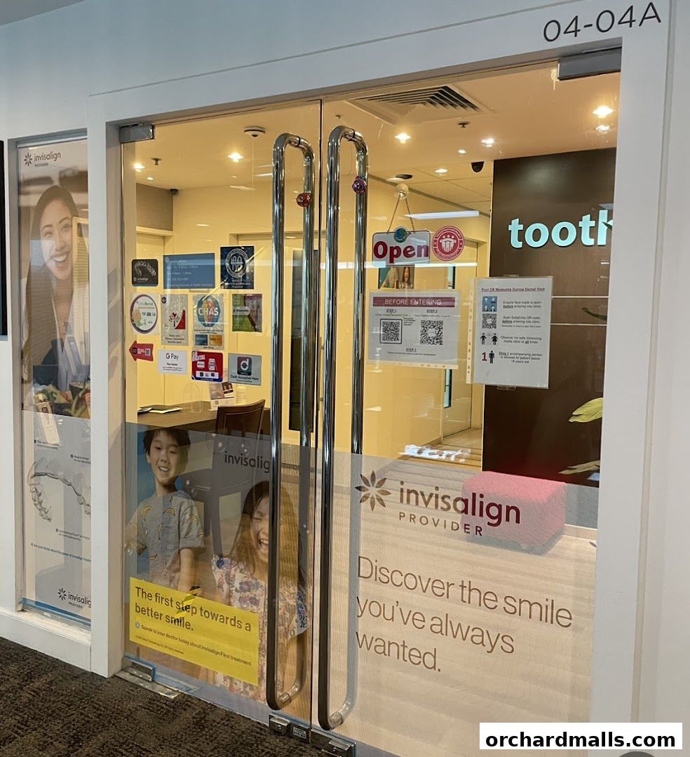 The entrance to Tooth Art Dental Centre, an Invisalign provider, with promotional posters.