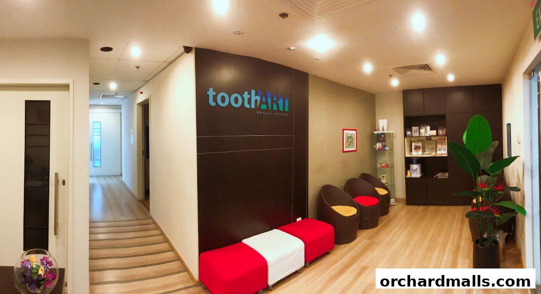 Interior view of Tooth Art Dental Centre's waiting area with seating and reception.