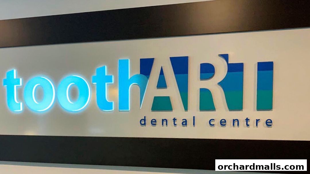 A close-up of the illuminated 'Tooth Art Dental Centre' sign with blue and green lettering.