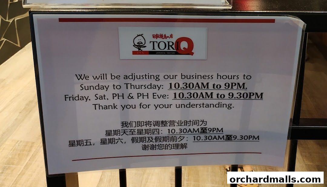 A sign announcing adjusted business hours for TORI-Q Japanese Yakitori.