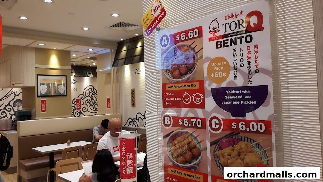A menu board for TORI-Q Japanese Yakitori, showcasing bento sets with prices and ingredients.