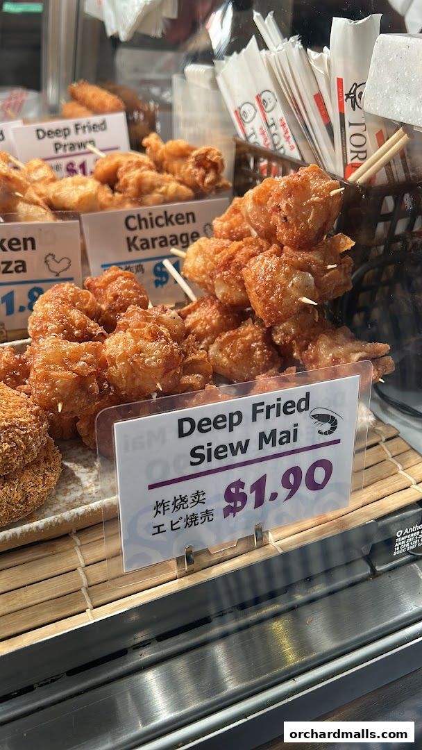 A display of various deep-fried Japanese snacks, including Deep Fried Siew Mai and Chicken Karaage.