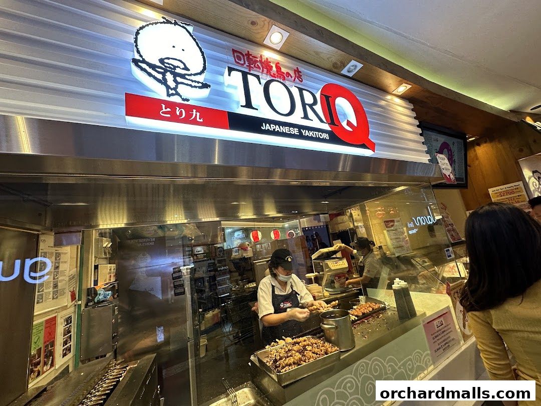 A TORI-Q Japanese Yakitori shop with staff preparing food behind a glass counter.