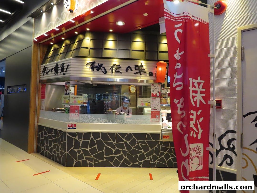 The TORI-Q ION Orchard shop front with a staff member behind the counter.